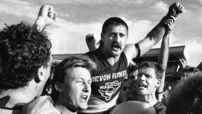 Woodville footballer Ralph Sewer is carried from the ground on the shoulders of his team-mates after his final game against West Torrens on September 8, 1990.