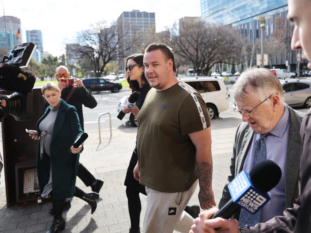 Joshua Dean Matthews threatened reporters outside Adelaide Magistrates Court before his brief appearance, but made no comment when he left alongside his lawyer. Picture: David Mariuz / NCA NewsWire