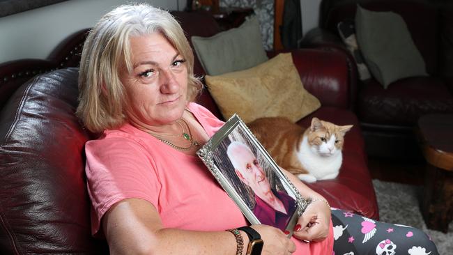 Rose Morton holds a portrait of her late father David Morton, who died from prostate cancer. Picture: Sarah Reed