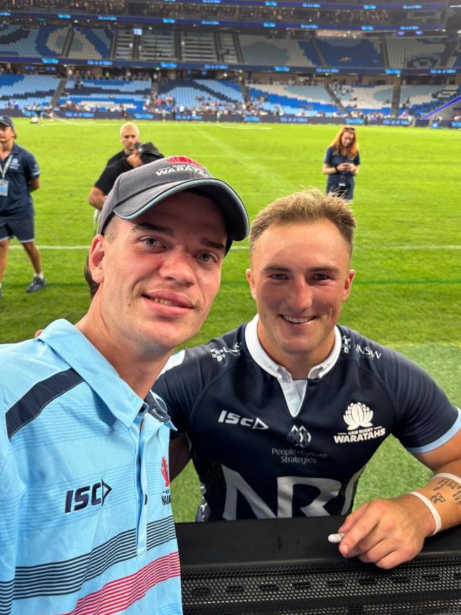 NSW fan Tom Perrott with his former schoolmate, Waratahs playmaker Jack Bowen, at Allianz Stadium.