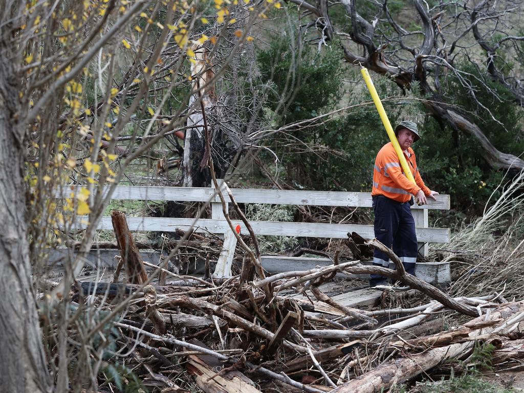 A Tas Networks employee surveys flood damage along Glen Dhu Road, Molesworth that has destroyed many of the bridges along the rivulet. Picture: JOANNE YOUNG