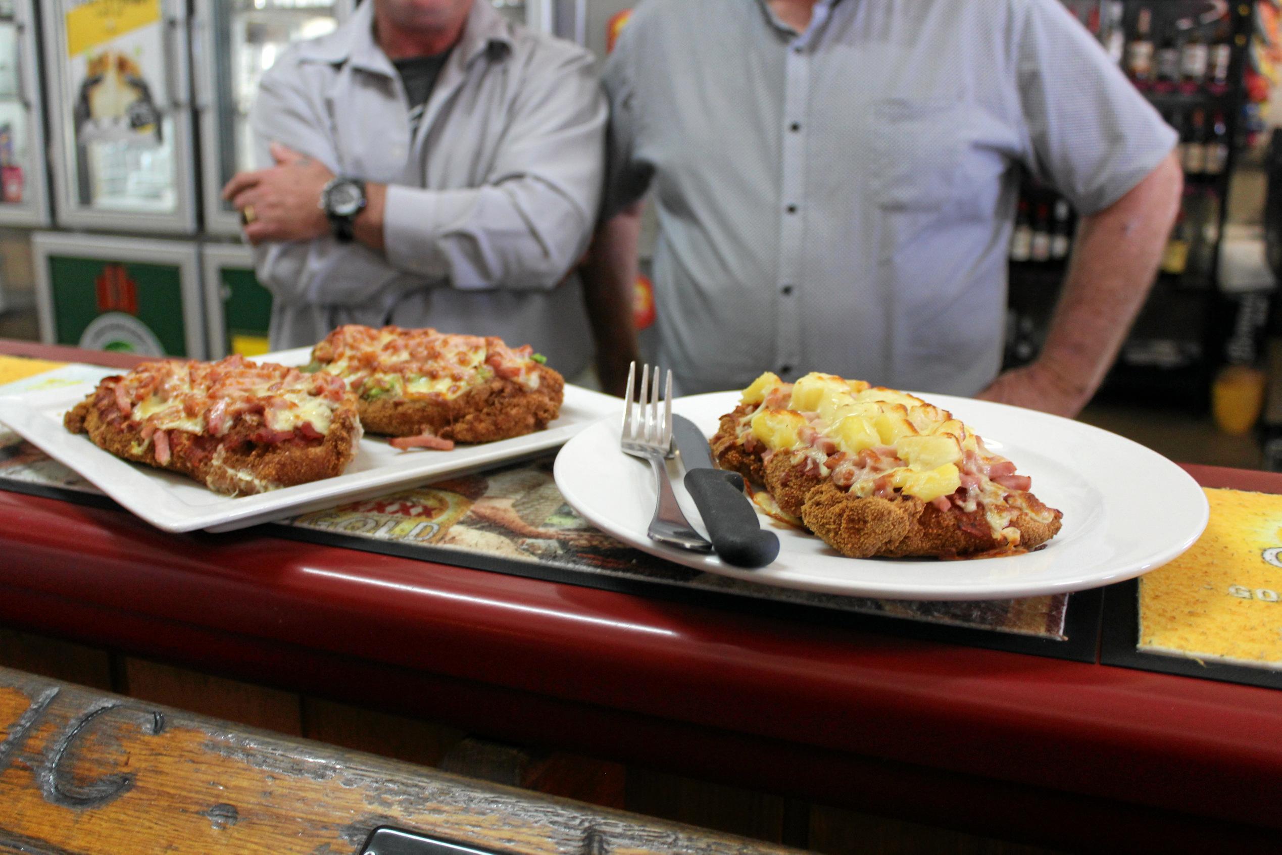 Three out of the five parmies served up at the Royal Hotel in Yarraman - the Hawaiian, Golden Buick and Traditional Chicken Parmies. Picture: Laura Blackmore