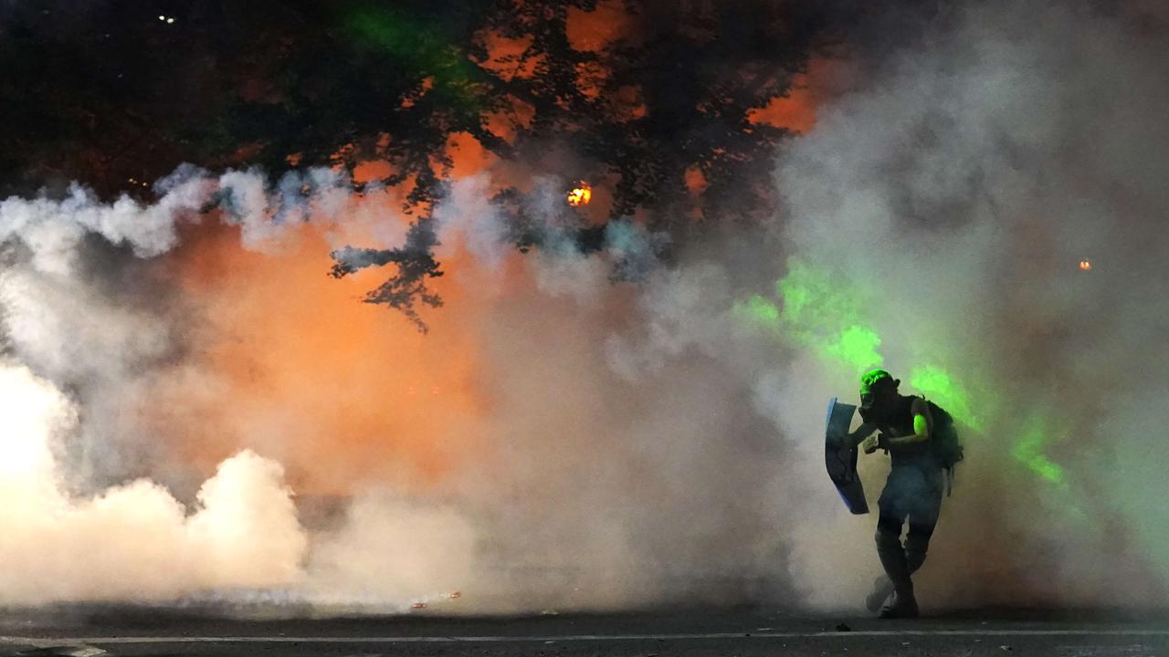 Federal officers highlighting a protester with a green laser in Portland to make him an easier target for less-lethal rounds. Nathan Howard/Getty Images/AFP