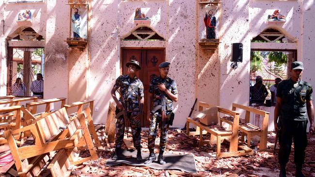 Sri Lankan soldiers inside the St Sebastian's Church in Negombo on April 21 following a bomb blast during the Easter service. Picture: STR/AFP