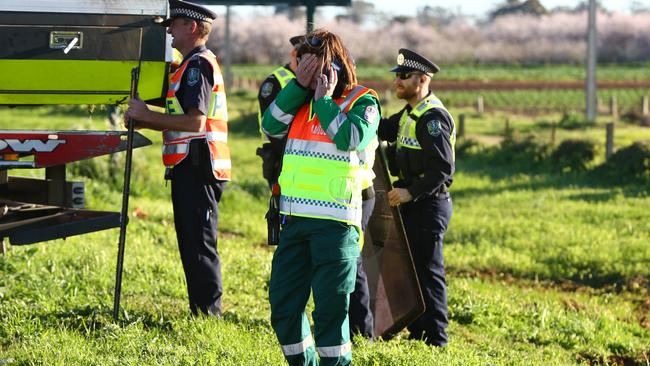 Police and a South Australian Ambulance Service staff member at the scene of the accident. Picture: Tait Schmaal