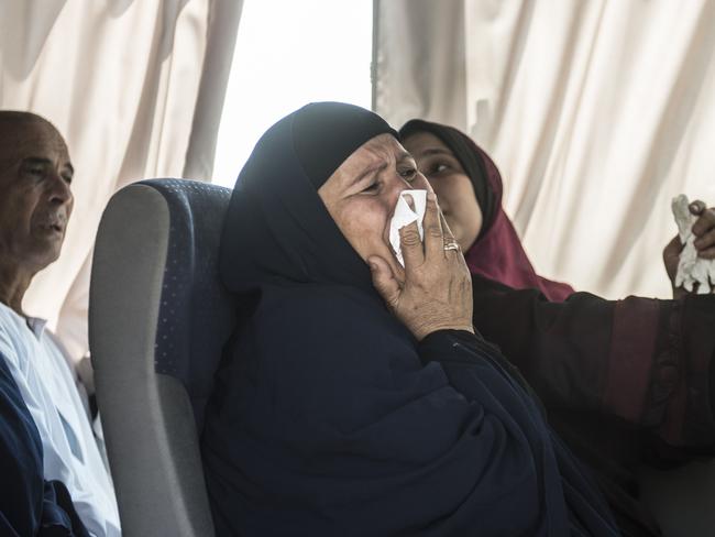 A relative of a passenger on-board is transported by bus to a gathering point at Cairo airport.