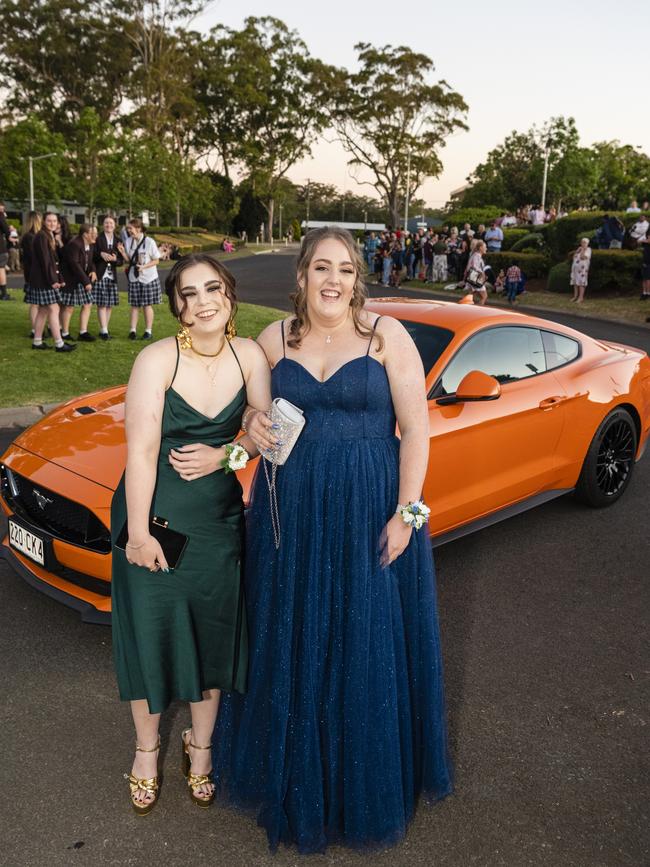 Lola Taylor (left) and Liana McEwan arrive at Harristown State High School formal at Highfields Cultural Centre, Friday, November 18, 2022. Picture: Kevin Farmer