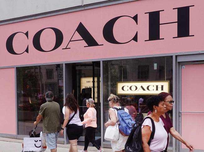 CHICAGO, ILLINOIS - AUGUST 10: Pedestrians walk past a Coach store on August 10, 2023 in Chicago, Illinois. Tapestry, the luxury fashion company that owns Coach and Kate Spade, has purchased Capri Holdings, the parent of Versace and Michael Kors.   Scott Olson/Getty Images/AFP (Photo by SCOTT OLSON / GETTY IMAGES NORTH AMERICA / Getty Images via AFP)