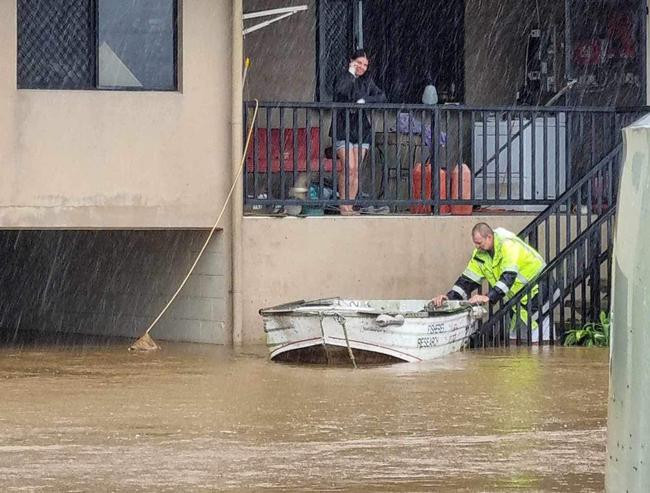 a Mossman family resorts to their trusty tinnie to navigate the rising floodwaters. Picture: Supplied