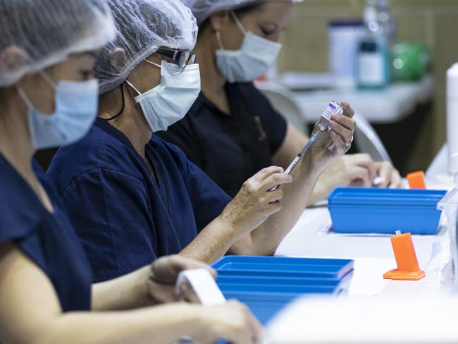 PERTH, AUSTRALIA - APRIL 28: Nurses are seen drawing up doses from a multi-dose vile of AstraZeneca Covid-19 vaccine at Claremont Showground on April 28, 2021 in Perth, Australia. The West Australian Government have opened up two new Vaccine Centres including one at Perth Airport. (Photo by Matt Jelonek/Getty Images)