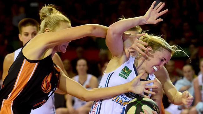 Britt Smart gets plenty of attention from Townsville Fire gun Suzy Batkovic.