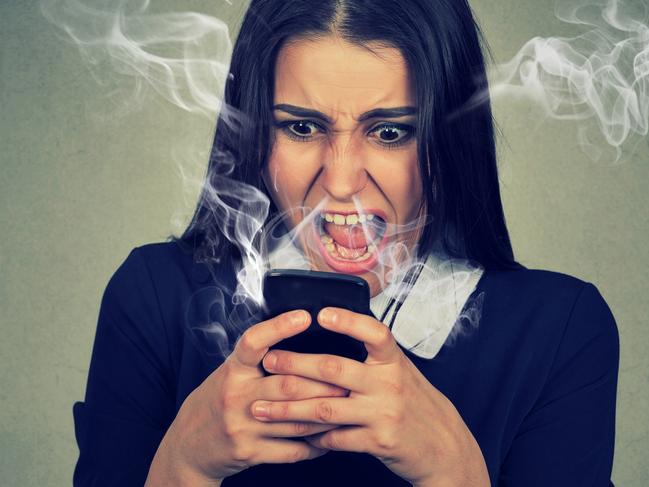 Portrait angry woman shouting at her cell phone, enraged with bad service, burning with rage. Negative emotions feelings face expression