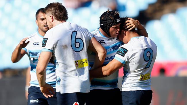 Nick Phipps (R) celebrates with teammates after his first half try.