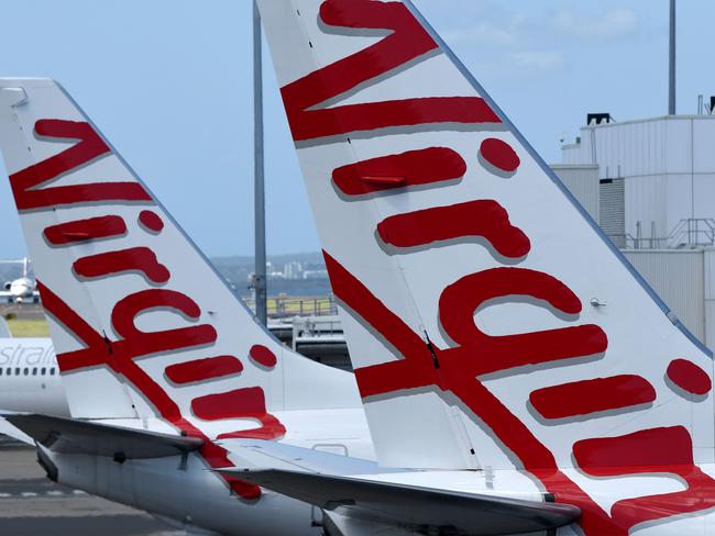 SYDNEY, AUSTRALIA - NCA NewsWire Photos FEBRUARY, 4, 2021: Virgin Australia aircraft are seen on the tarmac at Sydney Domestic Airport, Sydney. Virgin Australia says the end of JobKeeper in March could signal a mass shedding of workers if no further support is provided to the struggling aviation industry which has been out of action for almost one year. Picture: NCA NewsWire/Bianca De Marchi