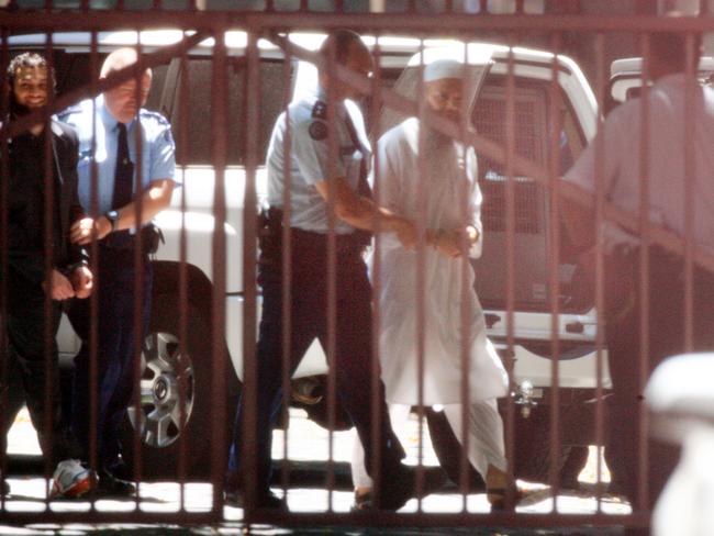 Muslim cleric Abdul Nacer Benbrika is escorted from the Victorian Supreme Court in Melbourne, after his conviction and sentencing on terrorism charges.