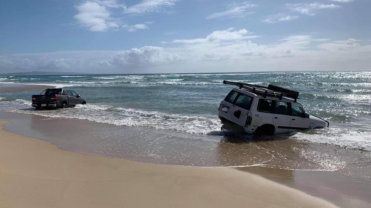 Two 4WDs were pulled out of the water at Teewah Beach after being submerged on the weekend. Pictures: Clayton's Towing