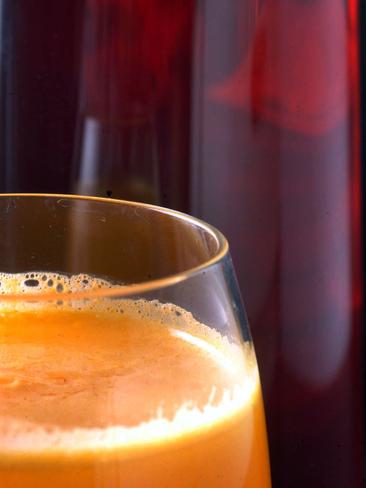 Fresh orange juice next to water infused with Rosella hibiscus flowers. Photo: DavidMartinelli