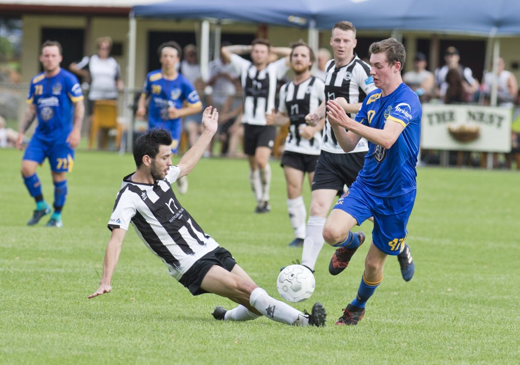 Callum Hart, Willowburn and Benjamin Adams, USQ. Football, Willowburn vs USQ. Sunday, 4th Mar, 2018. Picture: Nev Madsen