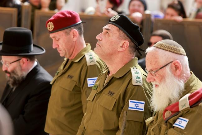 Outgoing Israel armed forces chief Lieutenant-General Herzi Halevi (C-L) and his successor, Lieutenant General Eyal Zamir (C-R) listen to a reading from the Torah during a visit to the Western Wall