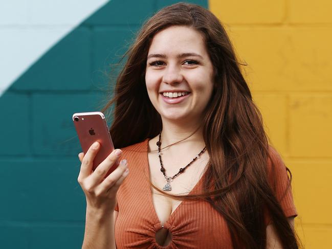 Australia's largest mobile phone network Telstra is changing its plans with an aim to attract new customers and to entice current customers to upgrade their phones. Kirra Watson, 19, of Kewarra Beach, is upgrading her current Telstra plan with a new one. PICTURE: BRENDAN RADKE