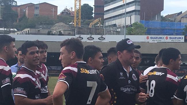 Marsden SHS coach Jesse Maclean with his subdued players after the semi-final win and, to his left, co-captain Konrad Tu’ua, whose steady reaction is typical of his understated role in the side.