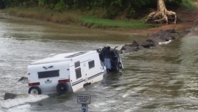 A motorist comes to grief trying to get a caravan across Cahills Crossing. PICTURE: John McNeur