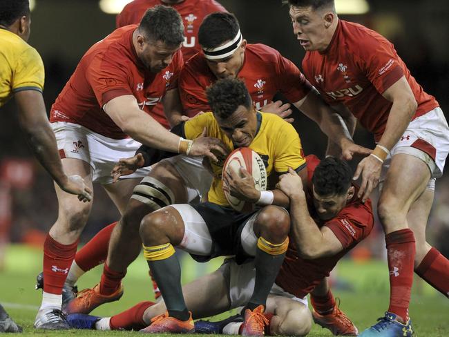 Wallabies star Will Genia is swamped by the suffocating Welsh defence. Picture: AP