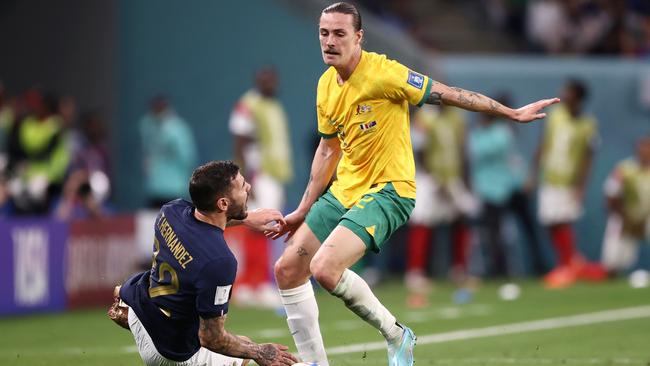 Theo Hernandez of France is tackled by Jackson Irvine.