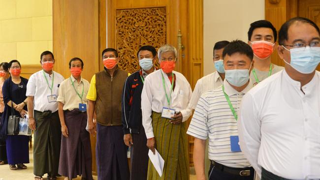 Members of parliament in Myanmar queue as they wait to receive a COVID-19 vaccine at the parliament building on Friday. Picture: AFP