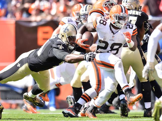 Terrance West #28 of the Cleveland Browns gets past a diving Cameron Jordan #94 of the New Orleans Saints.