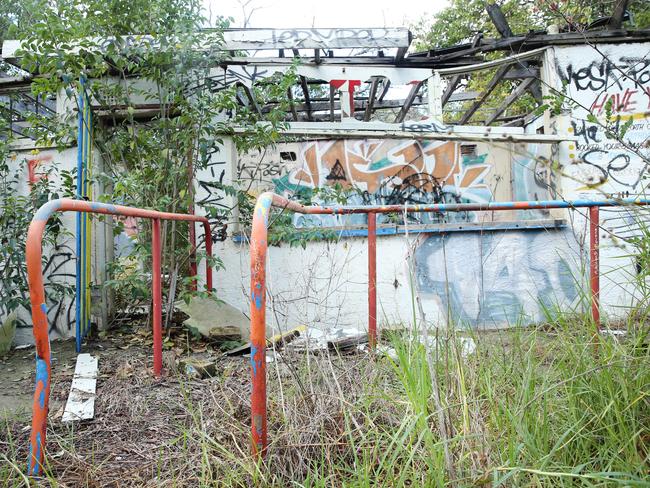 Vandals have drawn graffiti on the walls of what is left standing. Picture: Richard Dobson