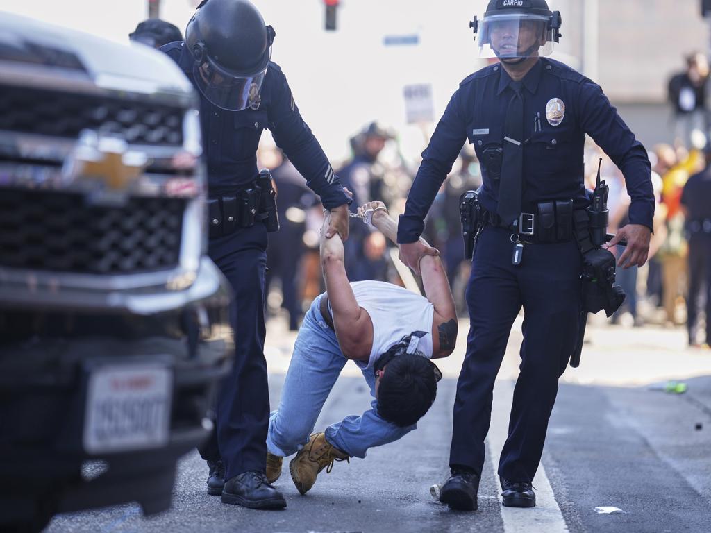 A protester is dragged away in downtown Los Angeles. Picture: AP
