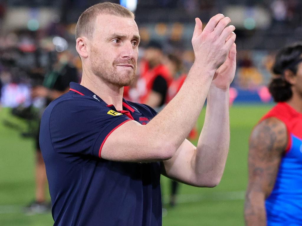 Simon Goodwin, senior coach of the Demons comforted Petty. (Photo by Russell Freeman/AFL Photos via Getty Images)