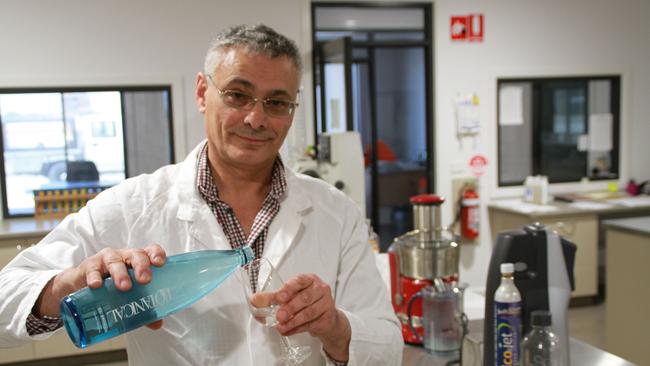 Dr Bruce Kambouris pours some water created through his technology.