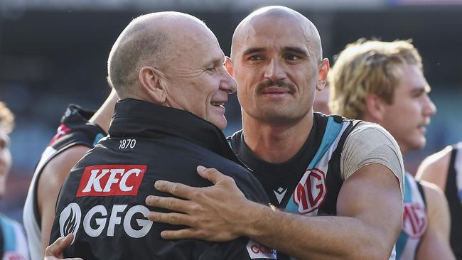 Ken Hinkley embraces Sam Powell-Pepper after a win.