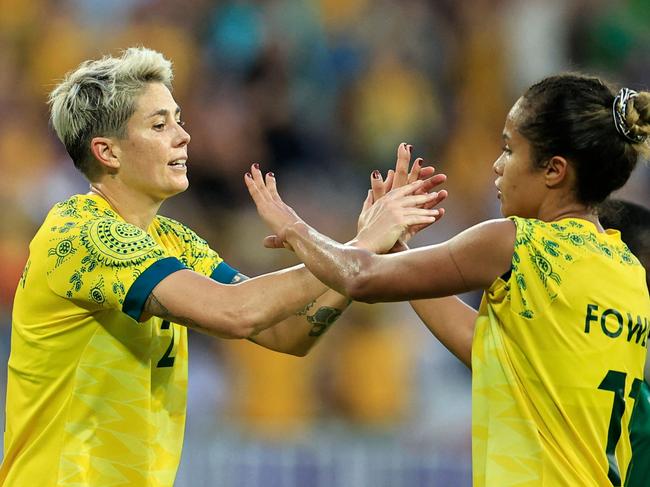 Australia's forward #02 Michelle Heyman celebrates scoring her team's sixth goal with Australia's forward #11 Mary Fowler in the women's group B football match between Australia and Zambia during the Paris 2024 Olympic Games at the Nice Stadium in Nice on July 28, 2024. (Photo by Valery HACHE / AFP)