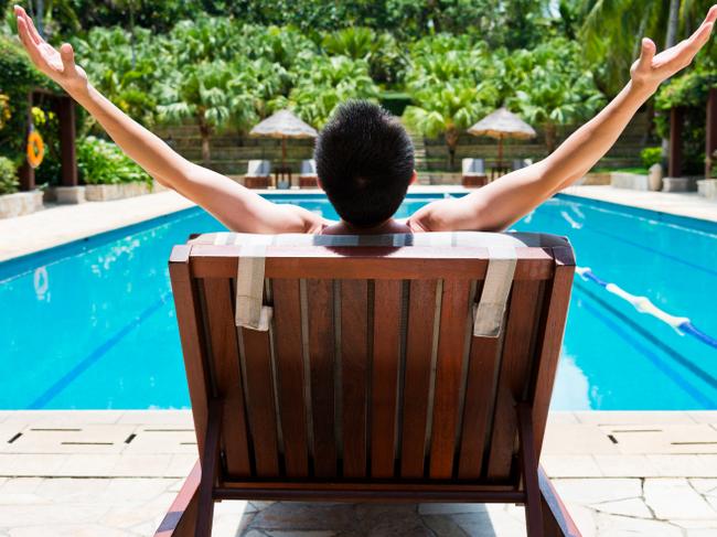 man sitting on a pool chair for relax.