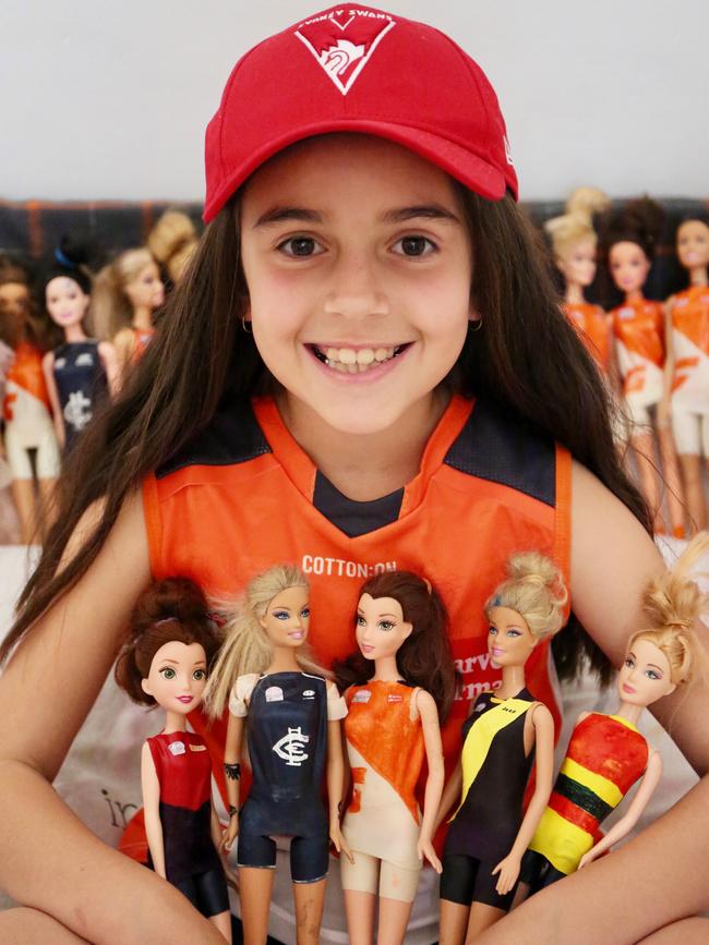 AFLW super fan Abbie Dare with her AFL dolls.