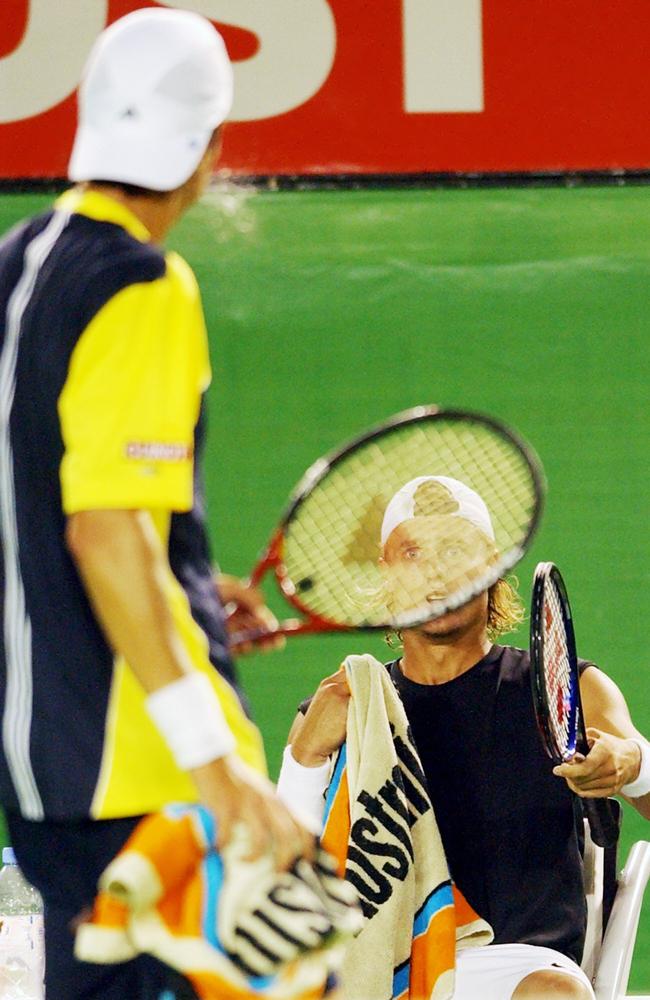 rgentina's Juan Ignacio Chela, left, appears to spit as he walks past Australia's Lleyton Hewitt during a break in their match at the Australian Open at Melbourne Park, in 2005, Picture: Photo/Rick Rycroft.