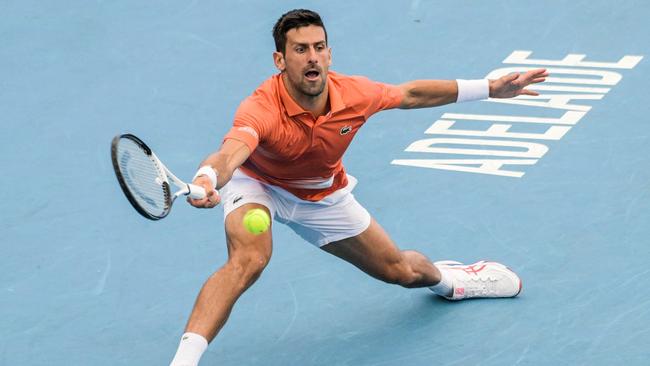 Serbia's Novak Djokovic hits a return against France's Quentin Halys during their men's singles match at the Adelaide International tennis tournament in Adelaide on January 5, 2023. (Photo by Brenton EDWARDS / AFP) / - IMAGE RESTRICTED TO EDITORIAL USE - STRICTLY NO COMMERCIAL USE-