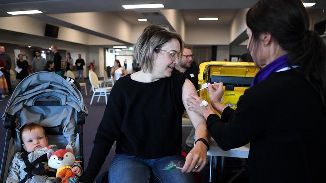 Brisbane resident Natalie Tomlin receives the Pfizer jab at a vaccination hub at the Doomben Racecourse. Picture: NCA NewsWire / Dan Peled