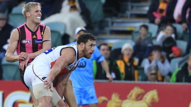 Will Langford snaps towards goal as Shane Mumford can’t smother. The Hawk’s tumbler bounced over Heath Shaw’s head to tie the scores. Picture: AAP