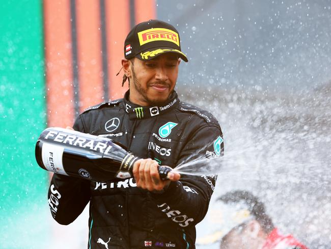 SPIELBERG, AUSTRIA - JULY 10: Third placed Lewis Hamilton of Great Britain and Mercedes celebrates on the podium during the F1 Grand Prix of Austria at Red Bull Ring on July 10, 2022 in Spielberg, Austria. (Photo by Clive Rose/Getty Images)