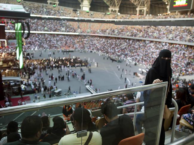 A woman enters to attend the "Greatest Royal Rumble" event in Jiddah, Saudi Arabia, Friday, April 27, 2018. A previous WWE event held in the ultraconservative kingdom in 2014 was for men only. But Friday night's event in Jiddah included both women and children in attendance. (AP Photo/Amr Nabil)