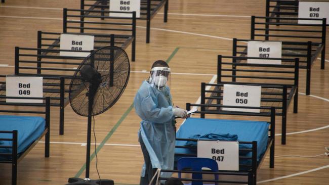 A nurse prepares beds for new patients at a makeshift Covid-19 hospital in Port Moresby. Picture: AFP