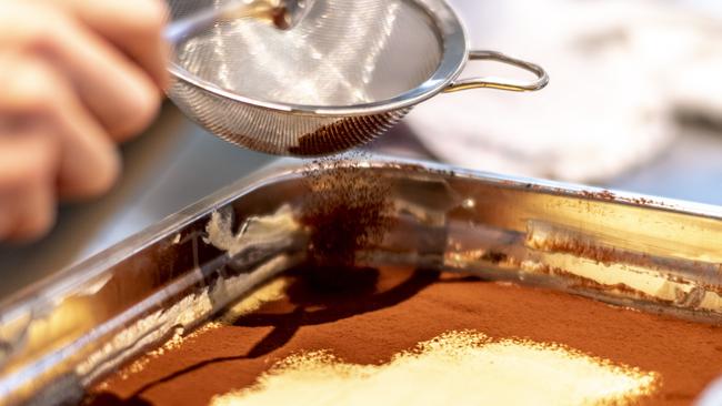 Nic Wong dusts tiramisu at CicciaBella. Picture: Monique Harmer