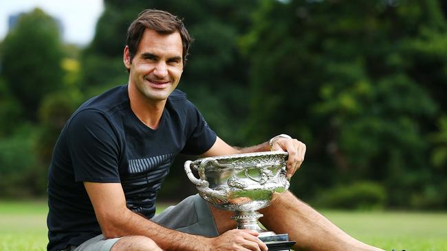 Roger Federer poses with the Norman Brookes Challenge Cup.