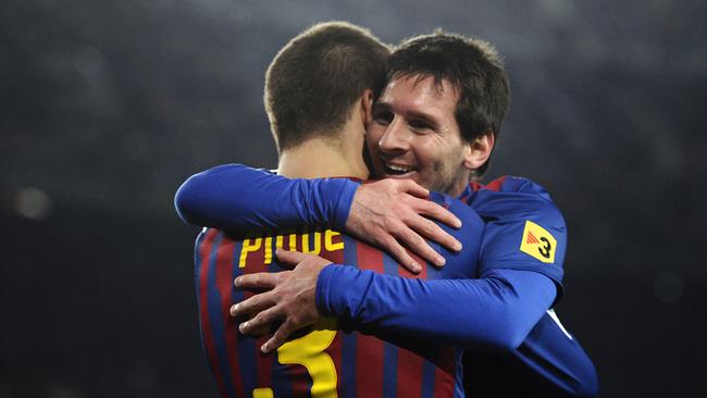 Lionel Messi of FC Barcelona (R) celebrates with his teammate Gerard Pique.