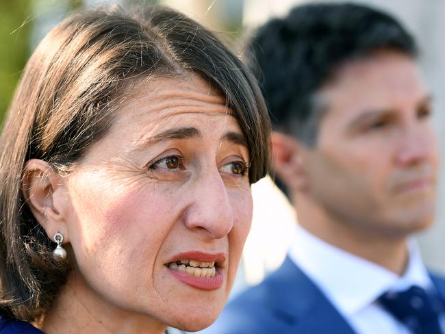 NSW Premier Gladys Berejiklian (left) and NSW Minister for Services Victor Dominello speak to the media after inspecting a new Service NSW bus at Revesby in Sydney, Tuesday, February 12, 2019. (AAP Image/ Joel Carrett) NO ARCHIVING