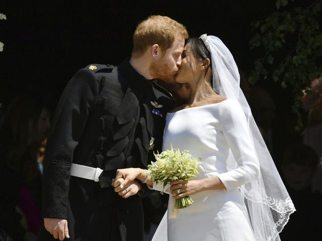 Britain's Prince Harry and Meghan Markle seal their love with a kiss. Picture: AP